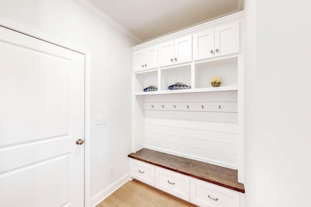 mudroom with crown molding and light hardwood / wood-style flooring