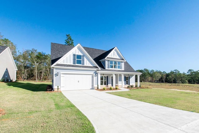 view of front facade featuring a porch, a garage, and a front lawn