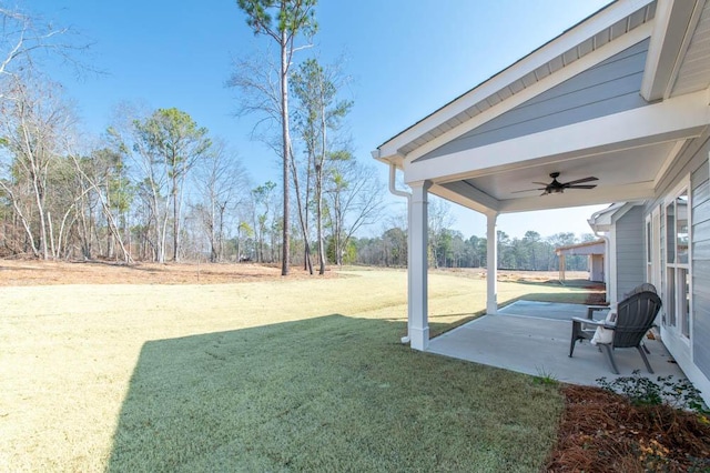 view of yard with ceiling fan and a patio area