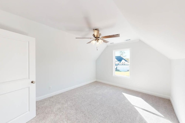 additional living space with lofted ceiling, light colored carpet, and ceiling fan