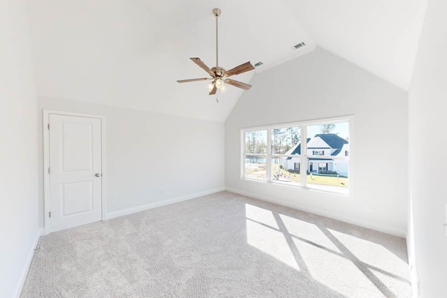 interior space featuring lofted ceiling, light colored carpet, and ceiling fan