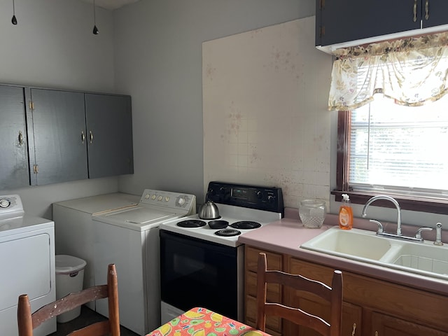 kitchen featuring sink, range with electric stovetop, and independent washer and dryer