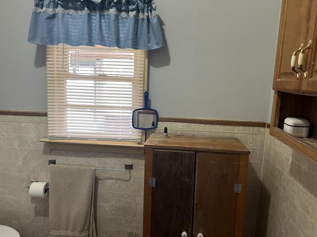 bathroom with tile walls