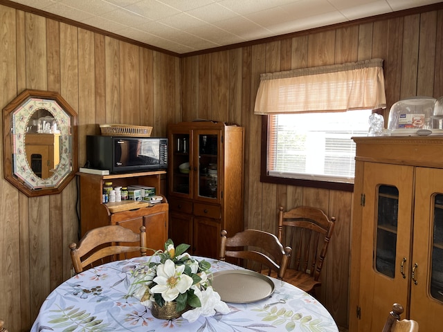 dining space with wood walls