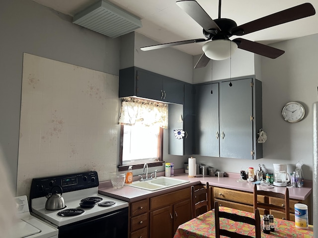 kitchen featuring electric stove, washer / clothes dryer, sink, and ceiling fan