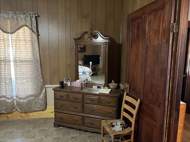 sitting room featuring wooden walls