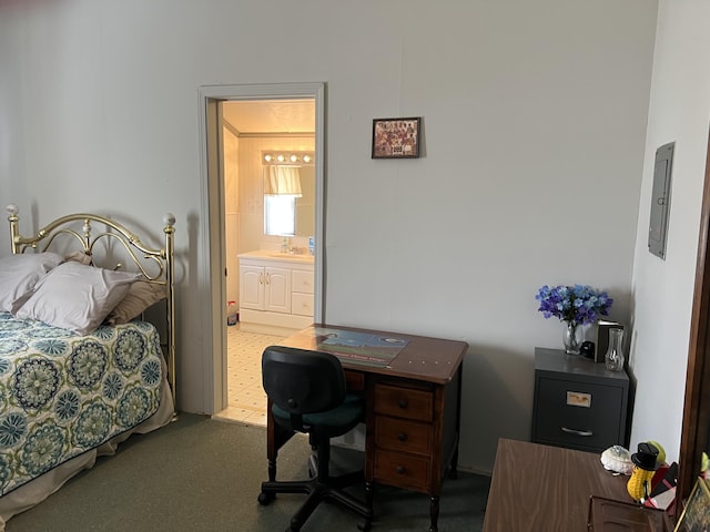 bedroom with carpet, connected bathroom, and sink