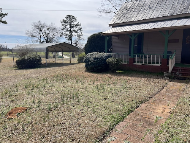 view of yard with covered porch and a carport