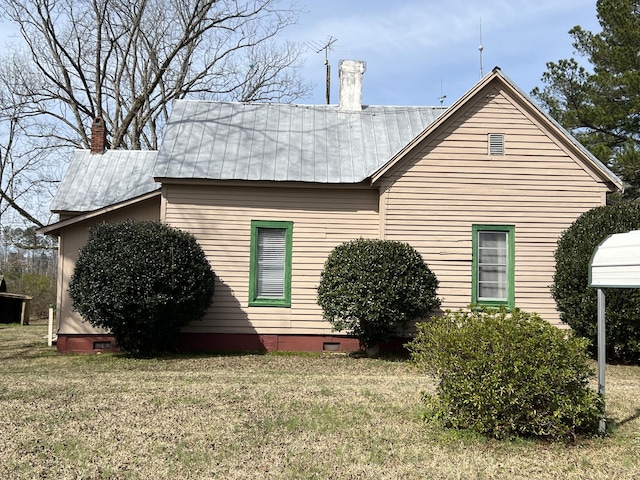 back of property with a lawn