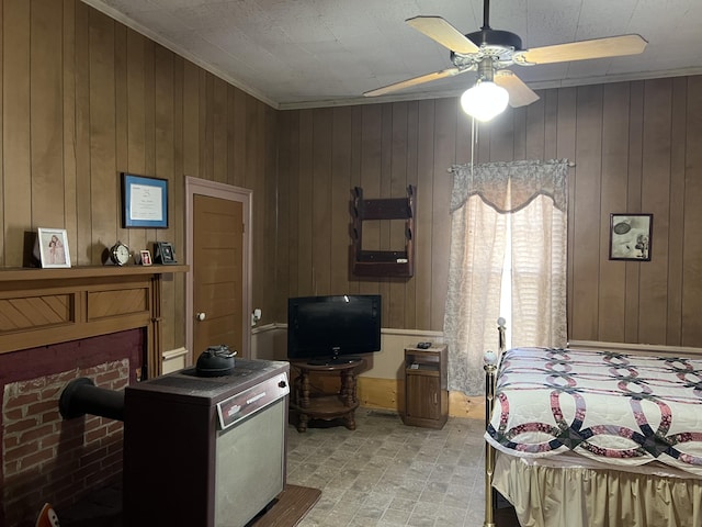 bedroom featuring ceiling fan and wood walls