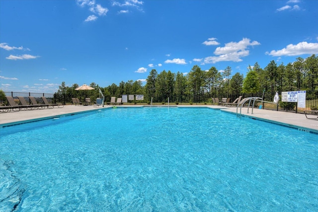 view of swimming pool with a patio