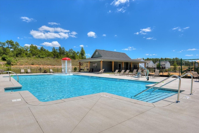 view of pool with pool water feature and a patio