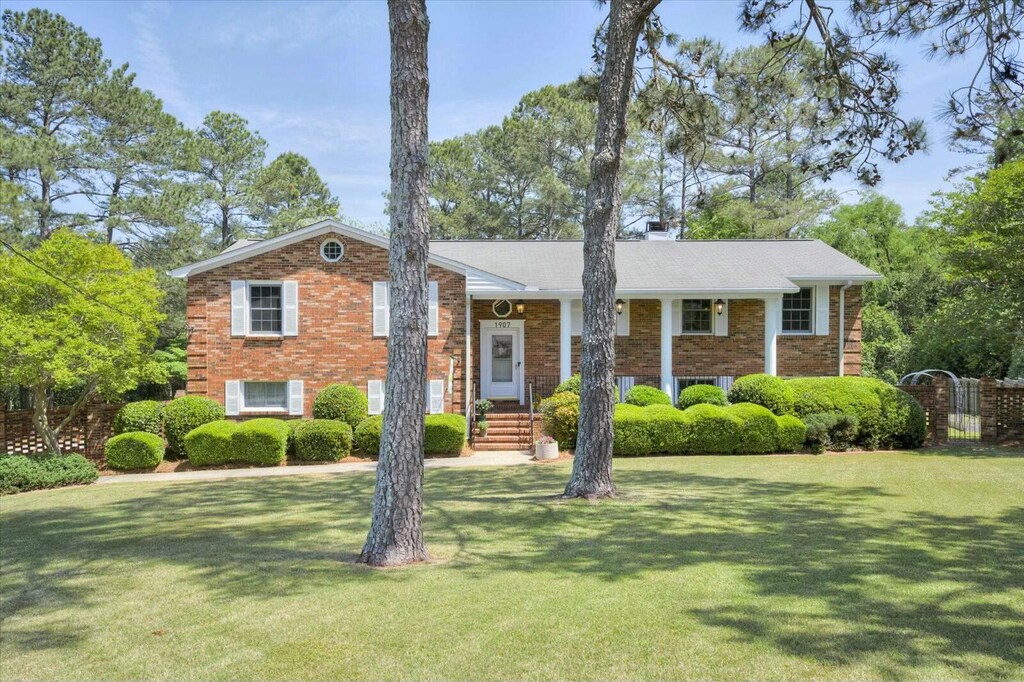 1907 Riley Ct, North Augusta, SC 29841 - view of front of property with a chimney, a front lawn, and brick siding