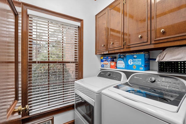 laundry room featuring cabinets and separate washer and dryer