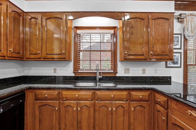 kitchen with black dishwasher, sink, and dark stone counters