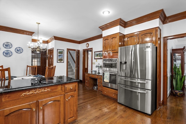 kitchen with appliances with stainless steel finishes, dark hardwood / wood-style floors, decorative light fixtures, dark stone counters, and crown molding