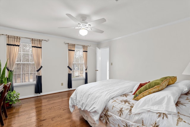 bedroom with crown molding, ceiling fan, and wood-type flooring