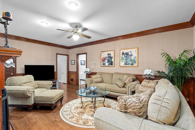 living room featuring crown molding, hardwood / wood-style flooring, and ceiling fan