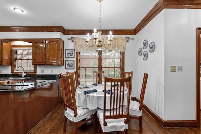 dining space featuring ornamental molding, sink, a chandelier, and dark hardwood / wood-style flooring