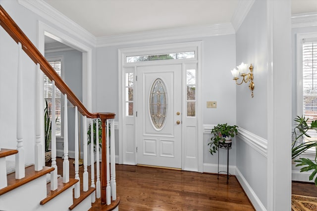 foyer featuring ornamental molding and dark hardwood / wood-style flooring