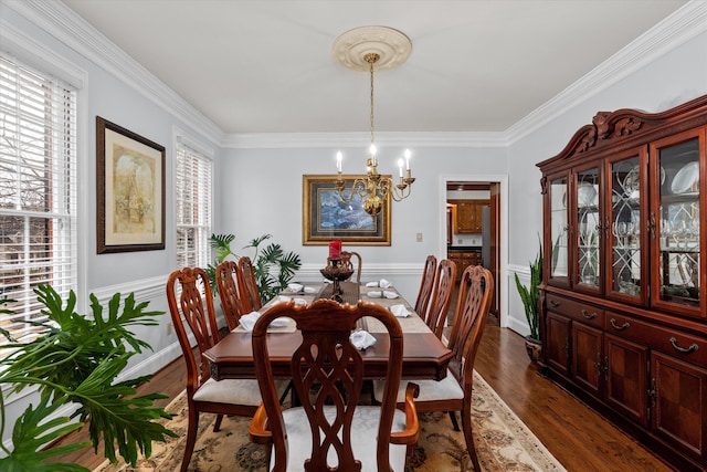 dining room with crown molding, dark hardwood / wood-style floors, and a chandelier