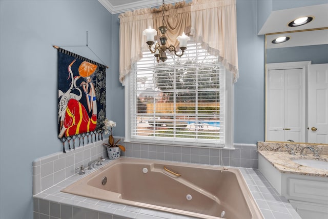 bathroom with an inviting chandelier, tiled tub, vanity, and ornamental molding