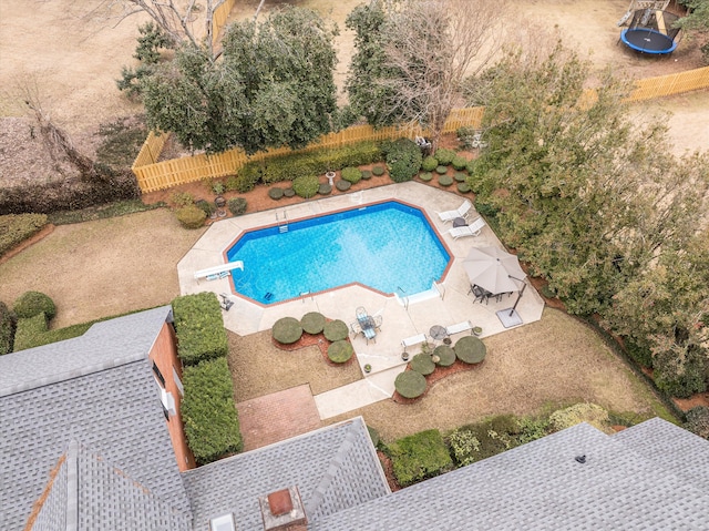 view of pool featuring a trampoline, a diving board, and a patio