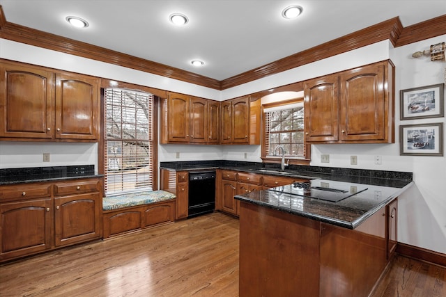 kitchen with dark stone countertops, sink, light hardwood / wood-style flooring, and black appliances