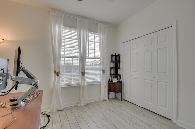 interior space with light wood-style flooring and baseboards