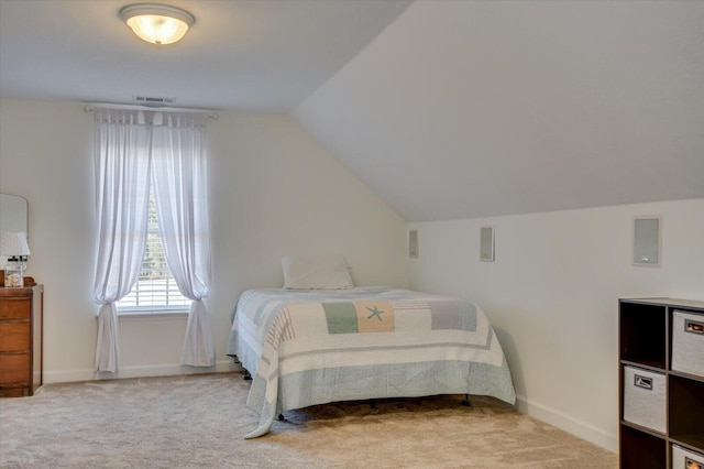 bedroom featuring light carpet, vaulted ceiling, and baseboards