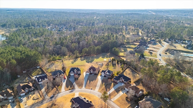 birds eye view of property featuring a forest view and a residential view