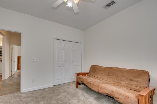 sitting room featuring a ceiling fan, visible vents, light carpet, and baseboards