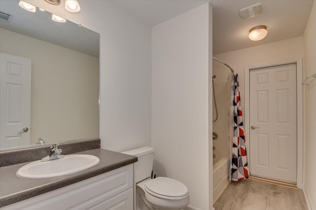 bathroom featuring visible vents, toilet, wood finished floors, shower / bathtub combination with curtain, and vanity