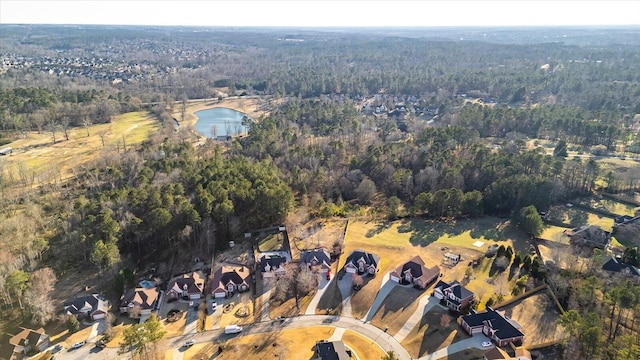 birds eye view of property with a water view and a view of trees