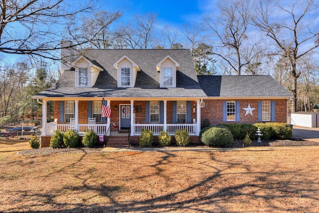 cape cod house featuring a front lawn and a porch