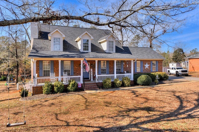 cape cod-style house with a porch and a front lawn