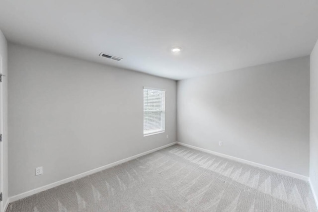 unfurnished room with light colored carpet