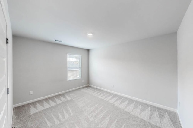 empty room featuring light carpet