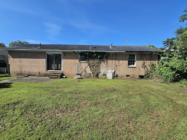 109 E E Walker St, Augusta, GA 30901 - back of house featuring entry steps, a yard, brick siding, and crawl space