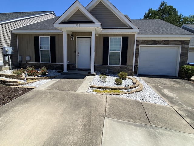 1908 Aspen Green Way, Augusta, GA 30909 - view of front facade with stone siding, a shingled roof, and a garage