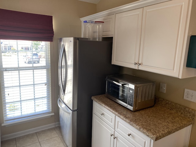 1908 Aspen Green Way, Augusta, GA 30909 - kitchen featuring light tile patterned floors, white cabinetry, freestanding refrigerator, and baseboards