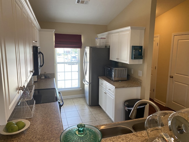 1908 Aspen Green Way, Augusta, GA 30909 - kitchen featuring appliances with stainless steel finishes, white cabinetry, vaulted ceiling, and light tile patterned floors