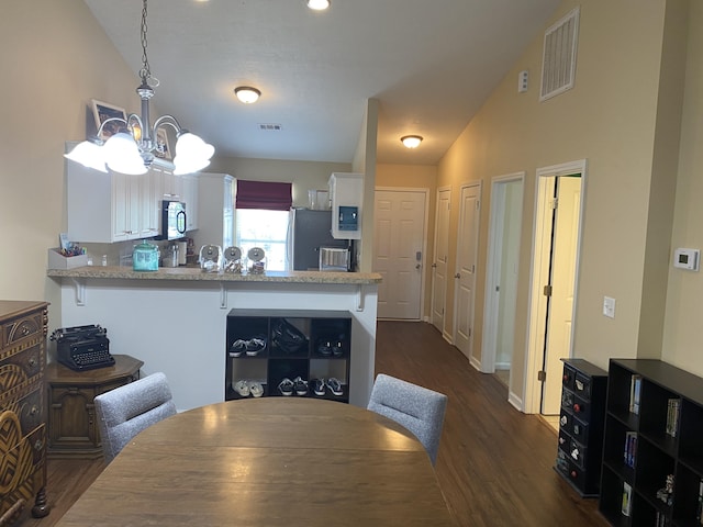 1908 Aspen Green Way, Augusta, GA 30909 - dining space with dark wood-type flooring, a chandelier, and vaulted ceiling
