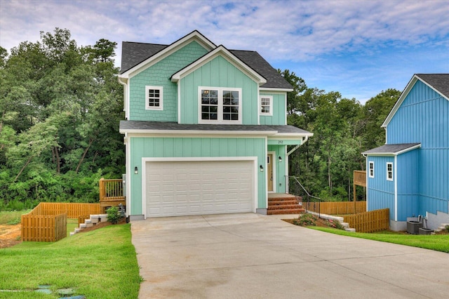 craftsman-style house featuring a garage and a front lawn