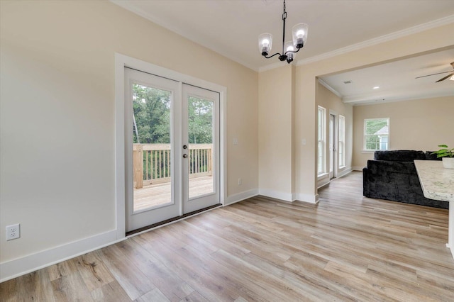 interior space featuring ceiling fan with notable chandelier, light wood-type flooring, and ornamental molding