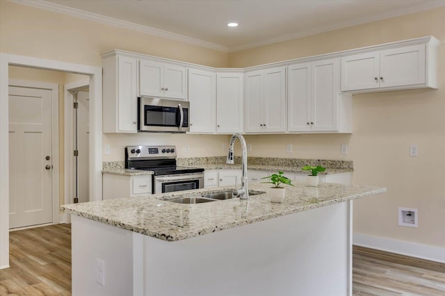 kitchen featuring sink, stainless steel appliances, light stone counters, light hardwood / wood-style floors, and white cabinets