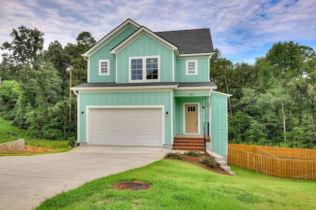 craftsman inspired home with a garage and a front yard