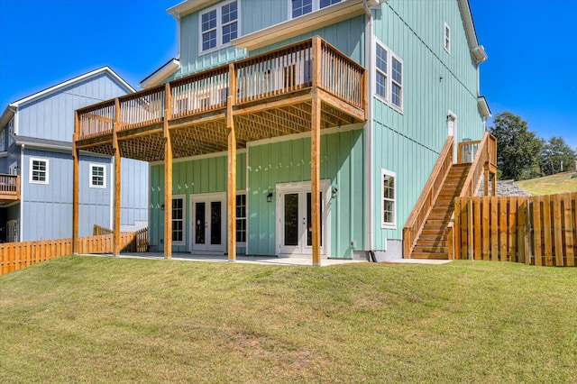 back of house with a yard, a patio, a wooden deck, and french doors