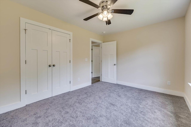 unfurnished bedroom featuring carpet, a closet, and ceiling fan