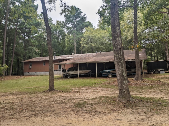 view of front facade with a front yard and a carport